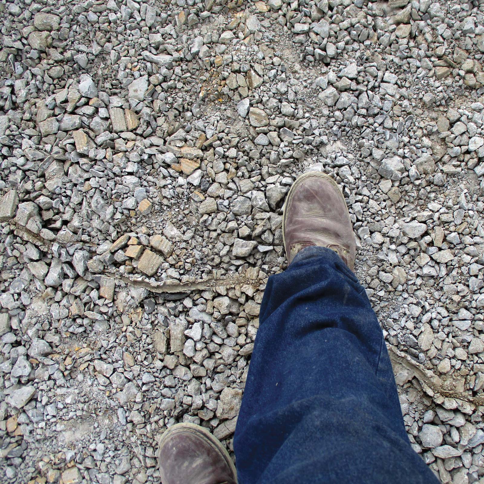 Boot stepping on rubbelized concrete