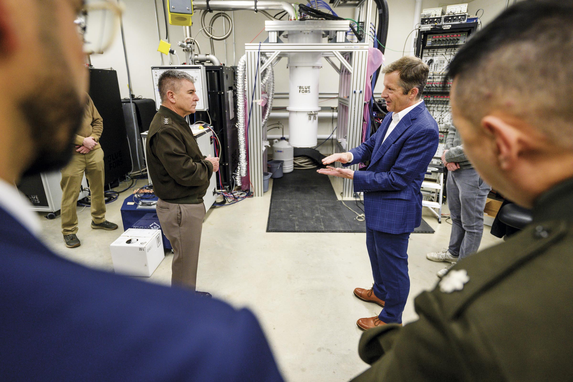 A physics professor gives a tour to a U.S. Cyber Command officer.